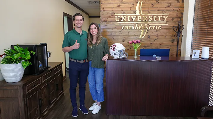 Chiropractor College Station TX Cole Roemer About Chiropractor, Dr Cole Roemer, smiling with his partner, Kensey Boykin at University Chiropractic in Bryan College Station, TX.