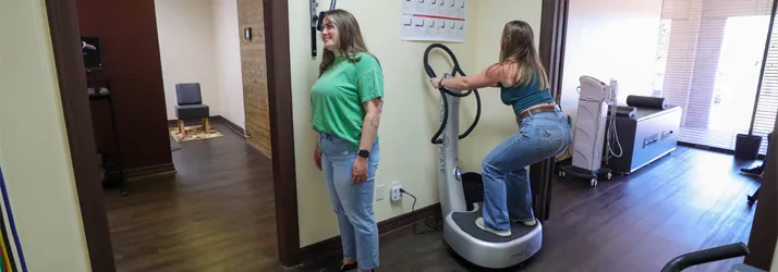 Chiropractor College Station TX Cole Roemer With Full Body Vibration Patients University Chiropractic patients engaging in rehabilitation therapies using the Nexxus and the Full Body Vibration Plate at University Chiropractic in Bryan College Station, TX.